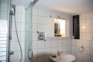 a bathroom with a sink and a glass shower at Panorama of Deep Blue in Tséria