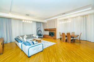 a living room with a couch and a table at Building Ferrari İn Front Port Baku in Baku +40 photos