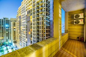 a view of a tall building from a balcony at Building Ferrari İn Front Port Baku in Baku