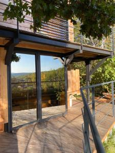 a view from the deck of a house with a balcony at Loft "Home, Sauna & Pool" in Osenbach