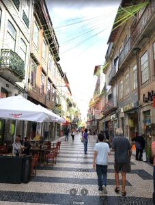 a group of people walking down a city street at BREINER 28 in Porto +17 photos