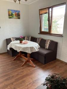 a living room with a couch and a table at Къща за гости Ягода in Sapareva Banya