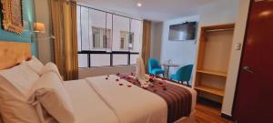 Ένα ή περισσότερα κρεβάτια σε δωμάτιο στο HOTEL LUZ GARDEN