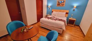 Ένα ή περισσότερα κρεβάτια σε δωμάτιο στο HOTEL LUZ GARDEN
