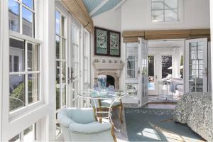 a living room with a table and a fireplace at Glamorous Cabana in Newburyport