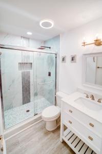 a bathroom with a shower and a toilet and a sink at Palm Paradise in Isle of Palms