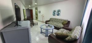 a living room with two couches and a tv at Vivienda Turística Colon in San Andrés