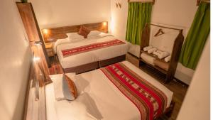 a view of a bedroom with two beds at MAMA GREEN Veggie Hostal & Permaculture Farm in Urubamba