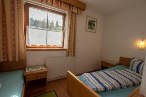 a small room with a bed and a window at Ferienwohnung zum Mühltal WILD025 in Wildschönau