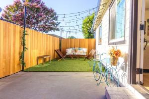 um quintal com uma cerca, uma mesa e cadeiras em Home in the heart of willow Glen San Jose em San José