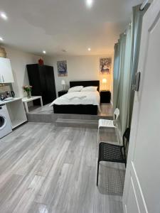 a large bedroom with a bed and a kitchen at Charming Studio Apartment in London in London