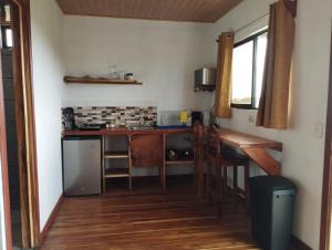 a small kitchen with a counter and a table at Siary Aparment 2 in Monteverde Costa Rica