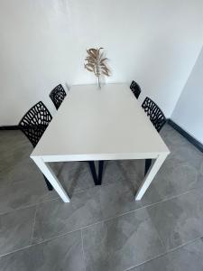 a white table with chairs and a plant on it at The rainbow 3 in Sofia