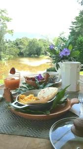 a table with a plate of food on a table at Aguas Claras Bamboo Ecolodge in Guaduas