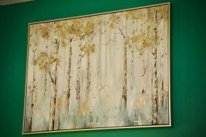 a painting of trees on a green wall at 1 Bed Apartment B in Birmingham