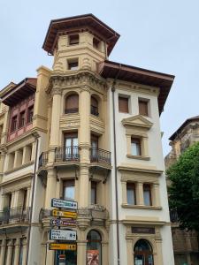 a tall building with signs in front of it at TARASKA BARRIA. Céntrico y coqueto en zona tranquila in Bermeo