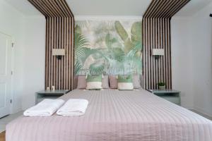 a bedroom with a large bed with a striped headboard at Wonderful 8Bd7BA Melbourne Beach w Pool Dock & Beach in Melbourne Beach +124 photos