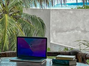 a laptop computer sitting on top of a table at Hotel Gallo de Mar in Puerto Escondido