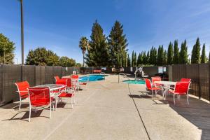 a patio with tables and chairs next to a pool at Motel 6-Dixon, CA in Dixon