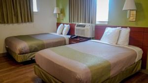 a hotel room with two beds in a room at Motel 6-Greensboro, NC - I-40 in Greensboro