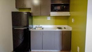 a kitchen with a black refrigerator and a sink at Motel 6-Greensboro, NC - I-40 in Greensboro