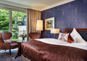 Ένα ή περισσότερα κρεβάτια σε δωμάτιο στο Maison Messmer - ein Mitglied der Hommage Luxury Hotels Collection