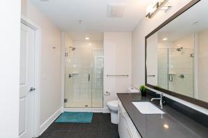 a bathroom with a shower and a sink and a toilet at Corporate Uptown Furnished Apartments in Charlotte +50 photos