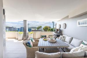 a living room with a couch and a table at Footprints 1 in Fingal Bay