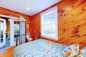 a bedroom with a bed and a wooden wall at Dancing Brook in Gatlinburg