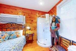 a woman standing in a bedroom with a shower at Dancing Brook in Gatlinburg
