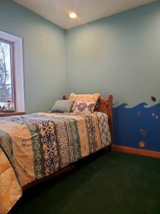 a bedroom with a bed in the corner of a room at 1913 LOVE SHACK BETHEL WHITE LAKE NY in White Lake