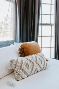 a pillow sitting on top of a bed with a window at Federal Hotel Mudgee in Mudgee