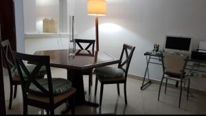 a dining room with a table and chairs and a desk at Beautiful Rooms at playa Blanca in Cancún