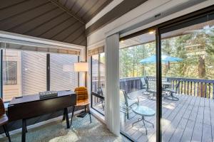 a balcony with a piano and a table on a deck at Huntington Lake Condo 115 in Lakeshore