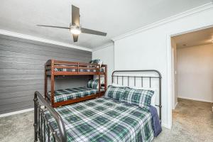 a bedroom with a bed and a ceiling fan at Huntington Lake Condo 115 in Lakeshore