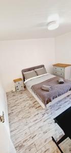 a bedroom with a bed and a wooden floor at City centre lovely Apartment with the Cheapest Overnight Parking in Leicester