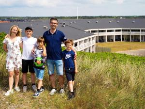 a family posing for a picture on the beach at 6 person holiday home on a holiday park in Ringk bing in Ringkøbing