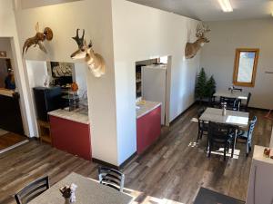 a restaurant with deer heads hanging on the wall at Glendive Lodge in Glendive