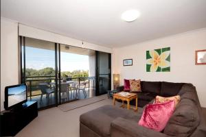 a living room with a couch and a television at The Dunes 17 38 Marine Drive fabulous unit with pool tennis court in Fingal Bay