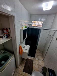 a small bathroom with a sink and a toilet at Recanto 101 in Praia Grande