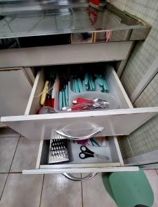 a drawer filled with lots of different colored utensils at Recanto 101 in Praia Grande