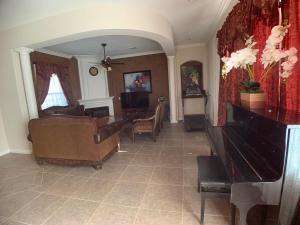 a living room with a couch and a piano at AirBB Rooms in Mansion in Riverside
