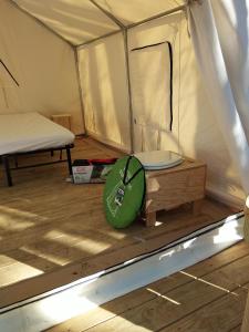 a tent with a bed and a table in it at Tentrr Signature Site - Exodus XX - A Private Lakefront Camp at Shabbat Retreat in Riverside