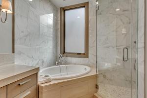 a bathroom with a tub and a glass shower at Premium Two Bedroom apartment hotel in Park City