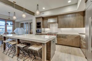 a kitchen with a large island with bar stools at Premium Two Bedroom apartment hotel in Park City