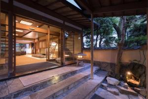 an external view of a house with a fireplace at Arima Onsen Gekkoen Yugetsusanso in Kobe
