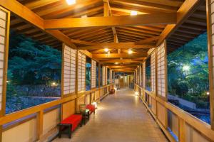 a hallway in a building with a mural on the walls at Arima Onsen Gekkoen Yugetsusanso in Kobe +42 photos