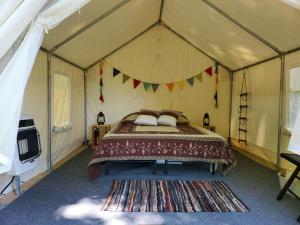 a bedroom with a bed in a tent at Tentrr Signature Site - Greener Acres Roan Mountain View in Roan Mountain