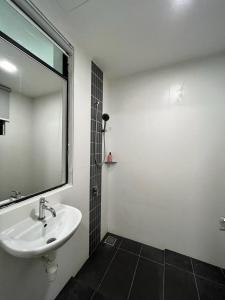 a bathroom with a sink and a mirror at Private Condo Port Dickson Waterfront in Port Dickson