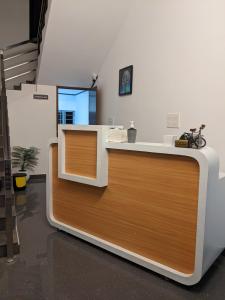 an office with a reception desk with a wooden counter at Atmos Inn in Kozhikode